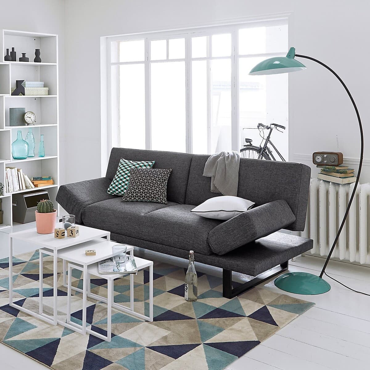 Sofá cama gris con patas metálicas