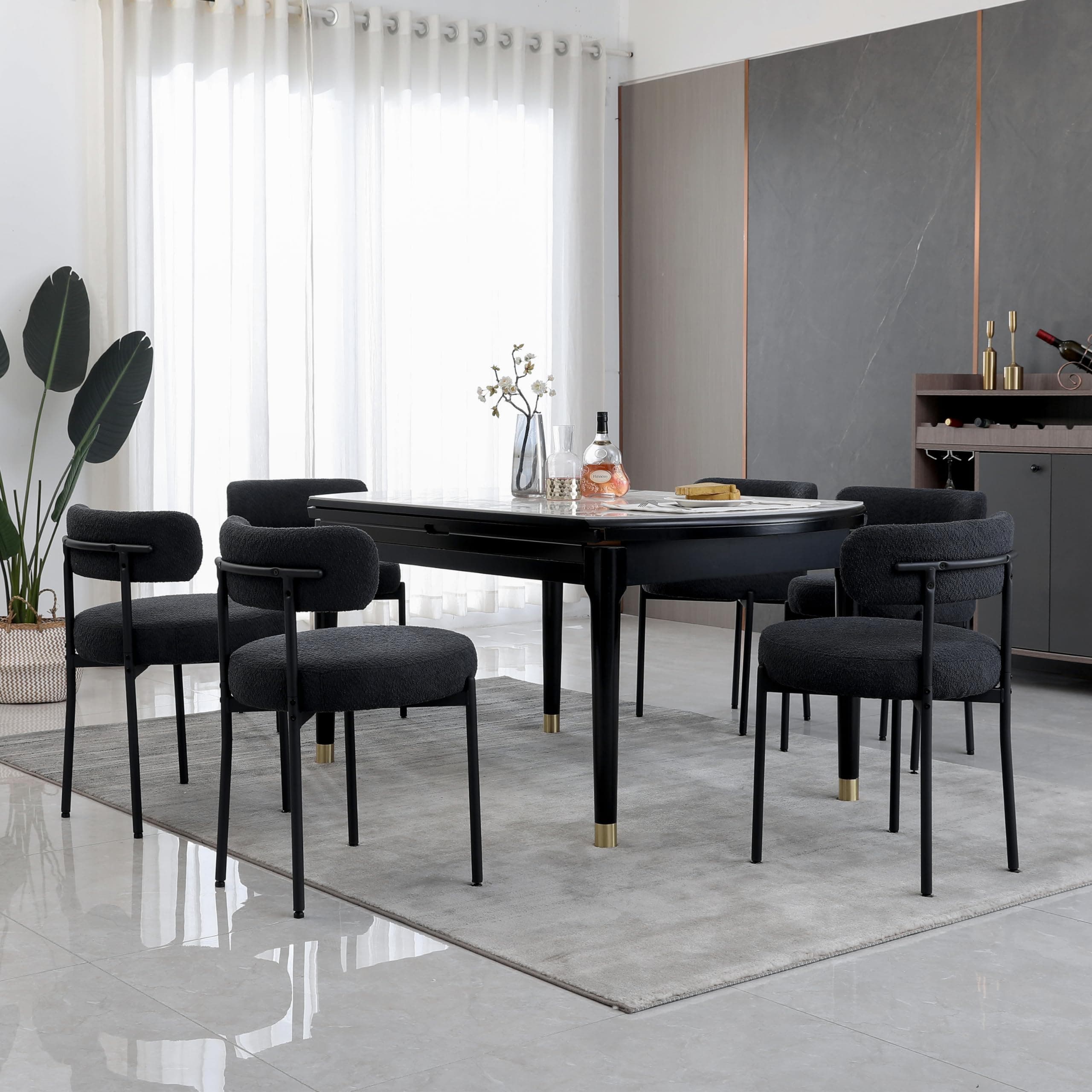 Juego de mesa de comedor ovalada negra con sillas tapizadas grises